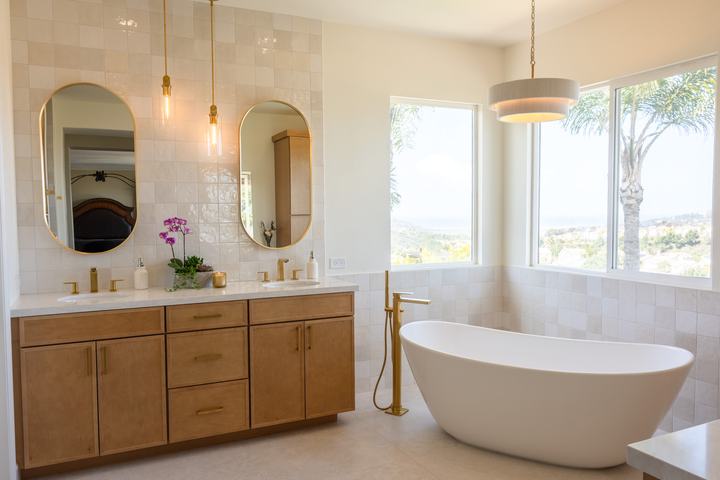 Wide view of vanity, tub, and tiled walls in spa bathroom.