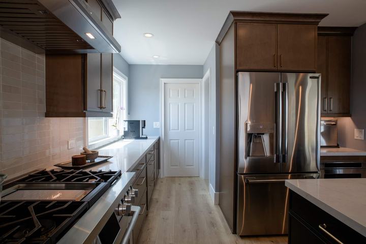 View down the kitchen with the range on the left and the french door refrigerator on the right