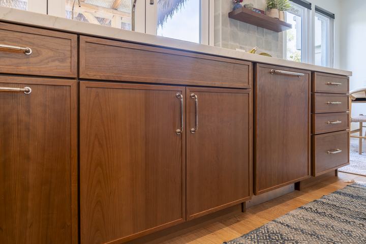 Long sink run with drawer bases and panel fronts in Cherry Amber under the expanded window