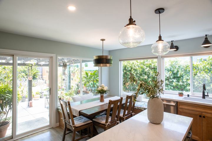 Dining area with pendants, sconces, and the sliding doors to the garden