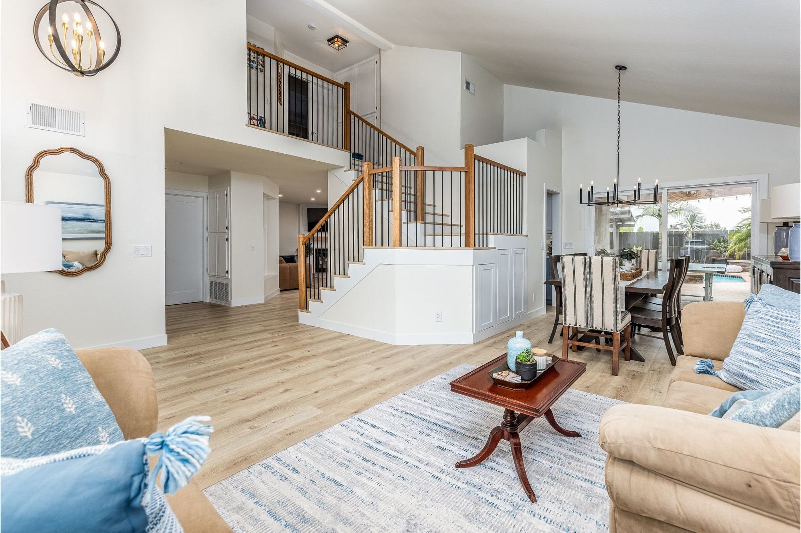 Open staircase, vaulted great room and new floors in a modern coastal whole-home remodel