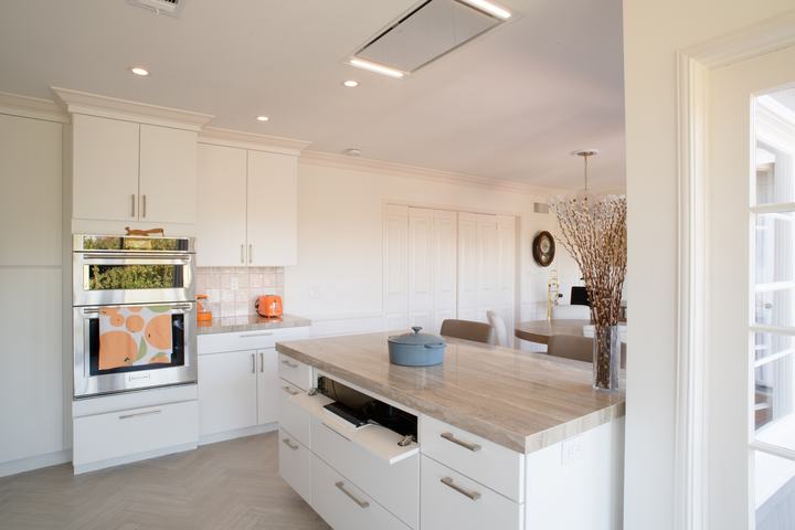 Tilt-down panel in the island opened to reveal the induction cooktop controls