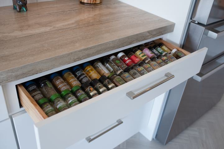 Pull-out drawer lined with rows of spice jars