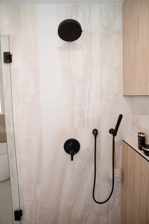 Delta rain shower head, valve, and handheld in dark bronze on onyx-look tile