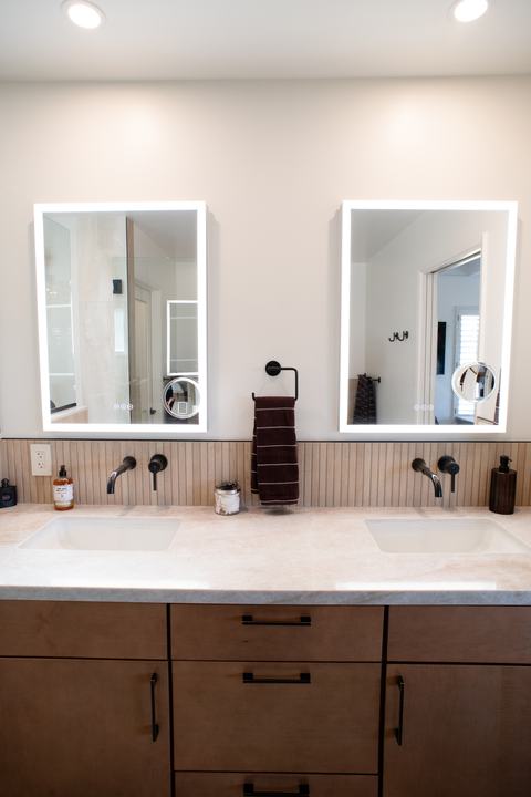 Maple Cider vanity with dark pulls, quartz top, and two lighted medicine cabinets
