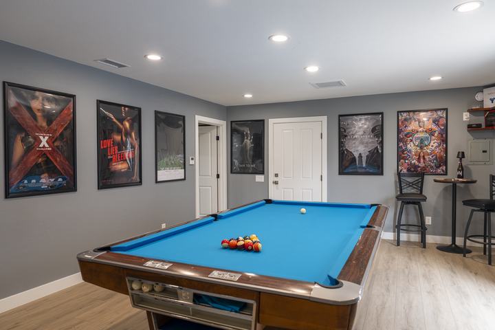 Game room pool table and gallery wall of posters