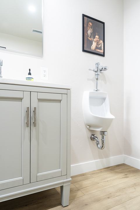 Compact urinal beside vanity, efficient bath layout