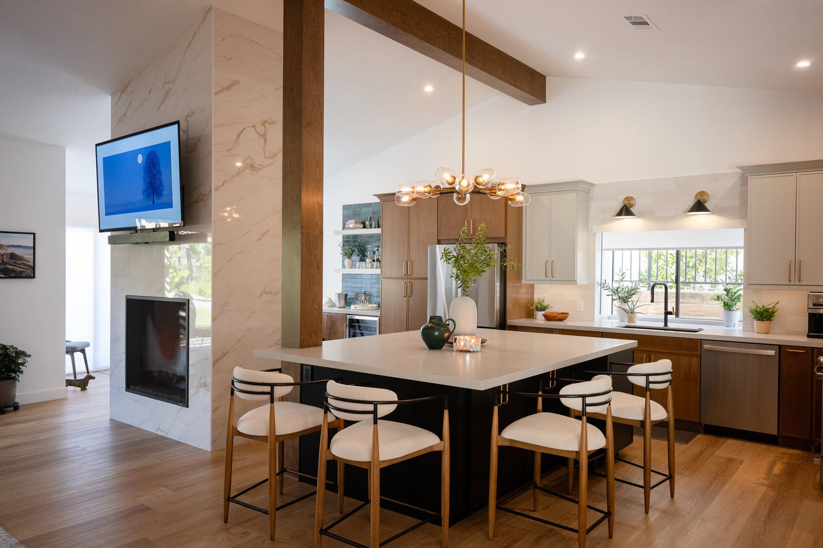 Open Vista kitchen with a large island and a double-sided fireplace