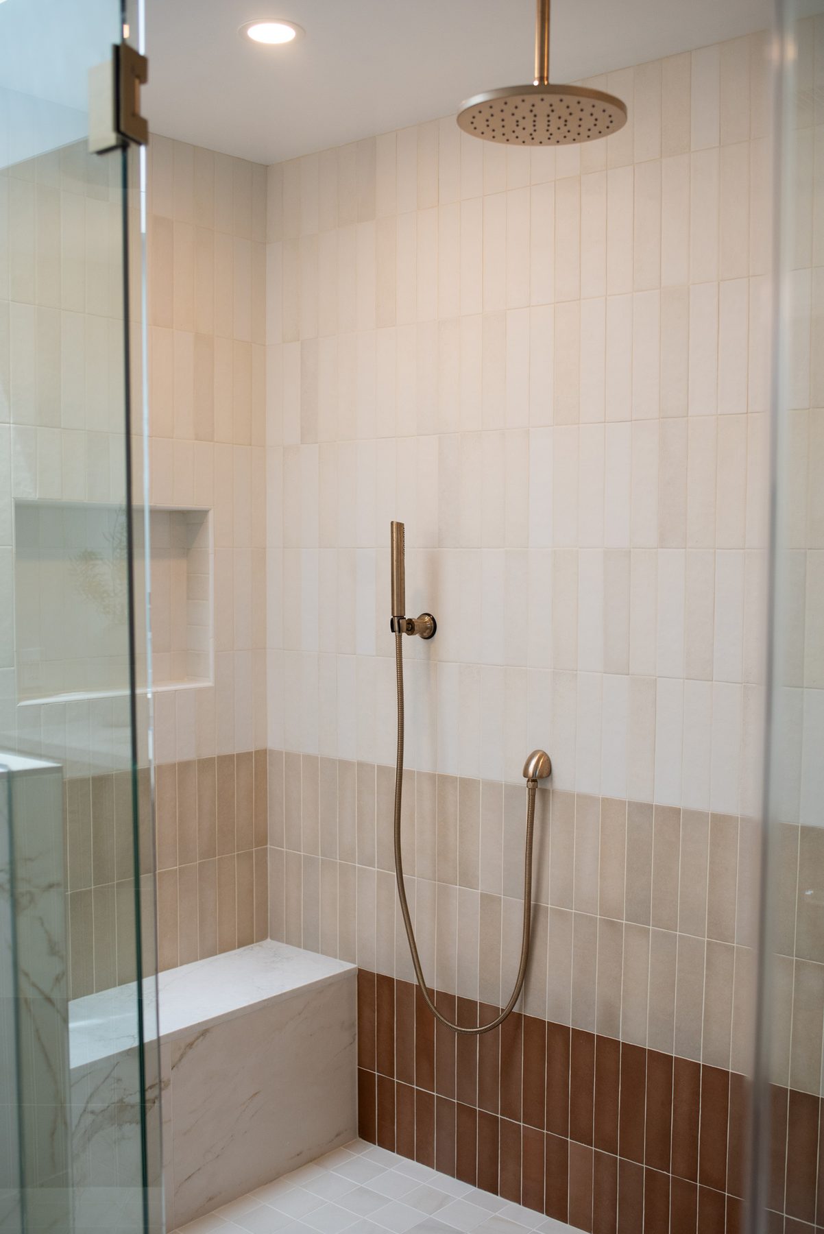 Ombre tile shower wall shifting from white to terracotta in a Del Mar master bathroom