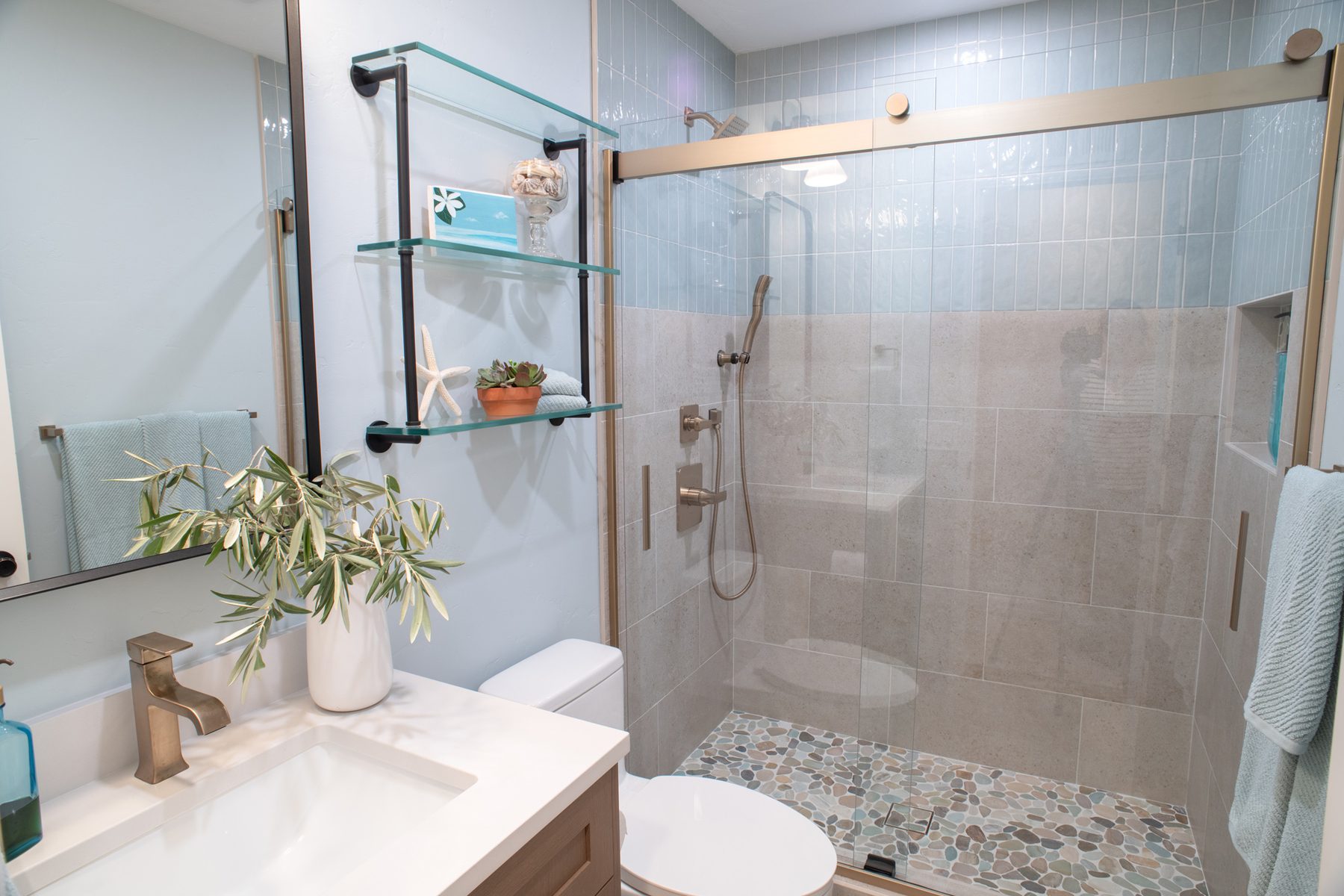 Freestanding vanity and tiled walk-in shower in a remodeled Mira Mesa hall bathroom