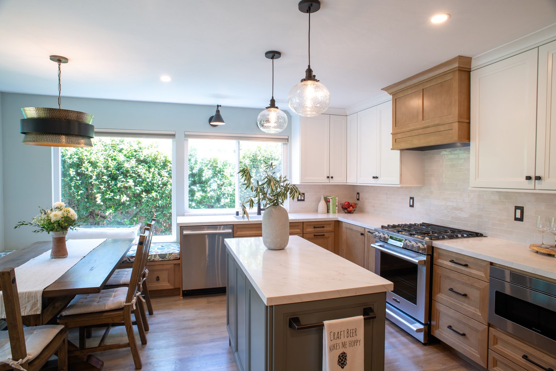 Remodeled Mira Mesa kitchen with a green island, maple cabinetry, and new lighting