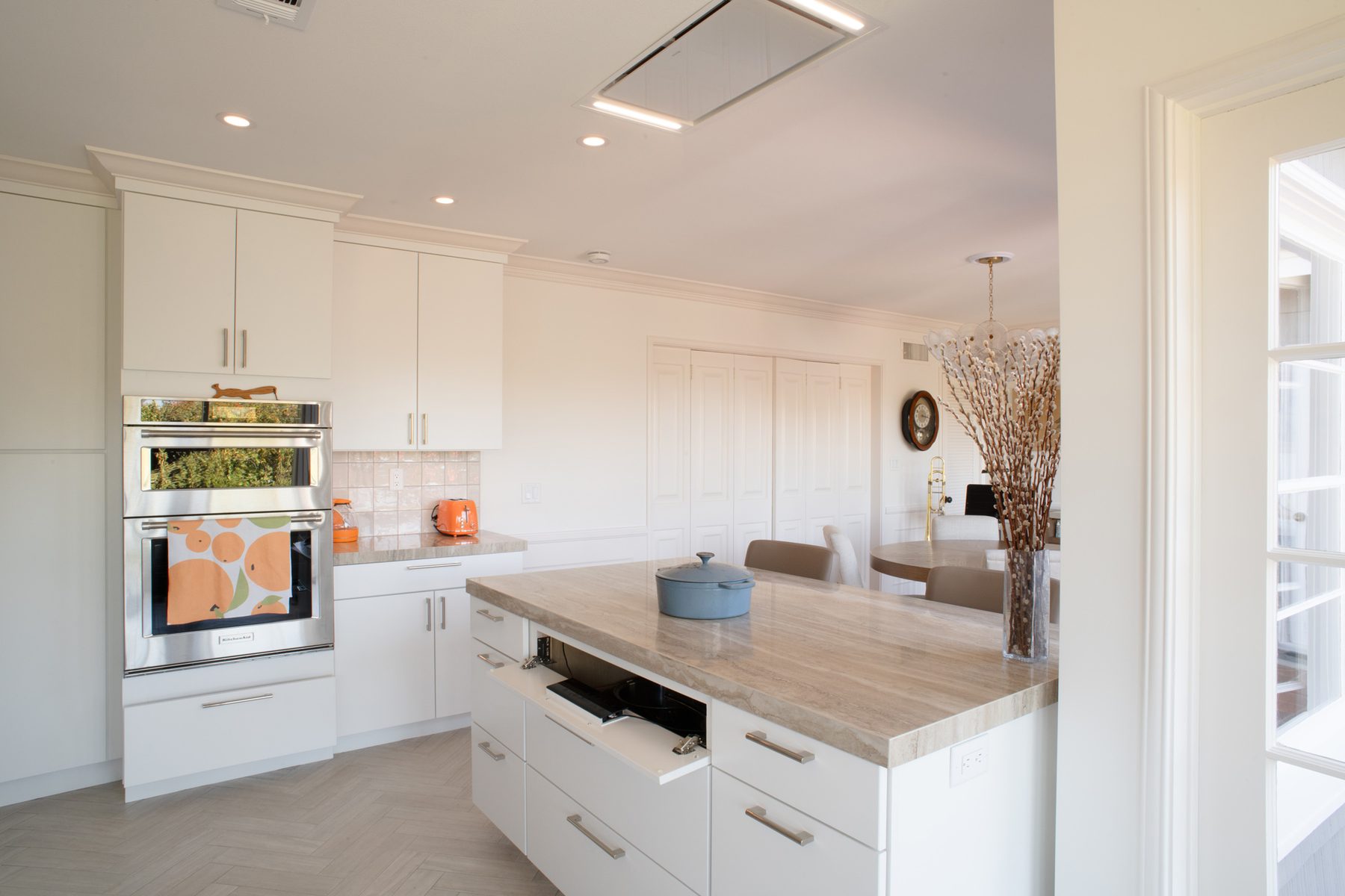 Hidden induction cooktop controls mounted inside a kitchen cabinet in a Point Loma remodel