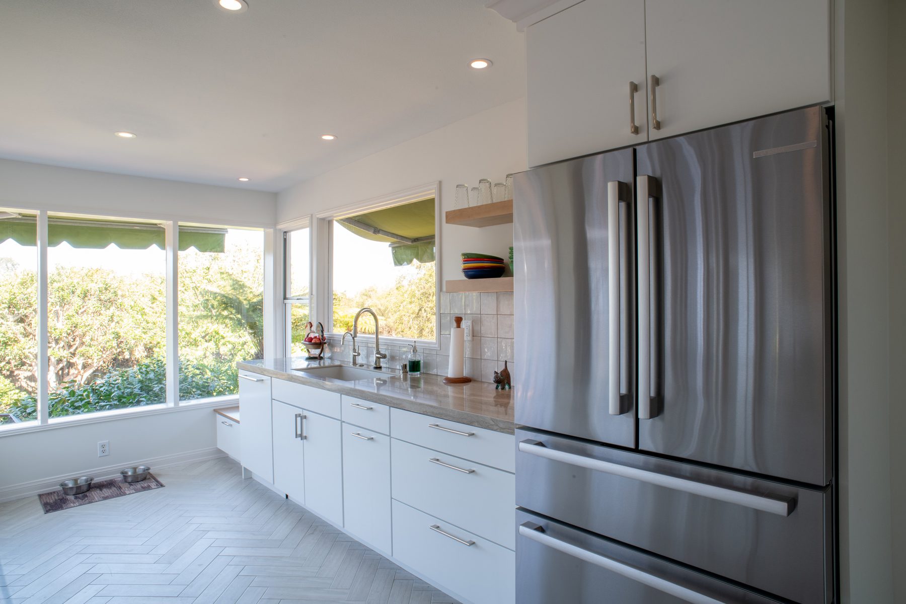 Point Loma kitchen sink wall with a built-in storage bench under the low window