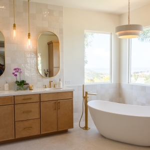 Wide view of vanity, tub, and tiled walls in spa bathroom.