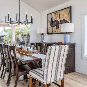 Dining room with black chandelier and rustic table