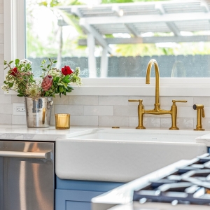 Apron sink, brass bridge faucet, quartz counter