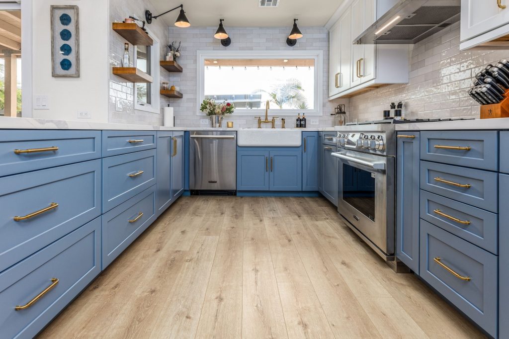 Kitchen with mixed metal finishes in brass, black, and stainless steel, San Diego design trend