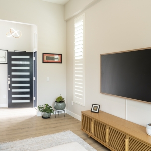 Natural light through large window, soft neutral furnishings
