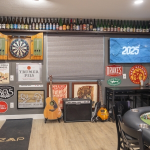 Dartboard corner with guitars and amplifier display