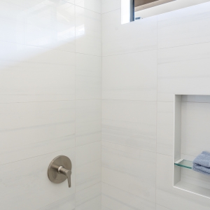 Kohler shower trim and tub spout over the Archer tub with large white wall tile