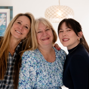 Design team and homeowner smiling in the completed primary bathroom remodel