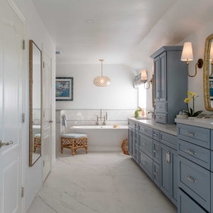 Wide view of El Cajon primary bathroom remodel with blue double vanity and freestanding soaking tub
