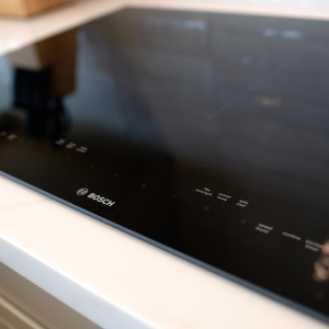 Bosch induction cooktop set into Calacatta-style kitchen countertop