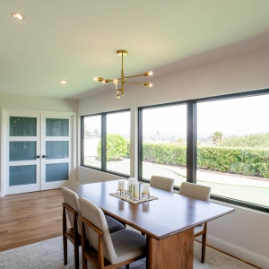 Dining area with large windows and white oak floors in a Rancho Bernardo remodel