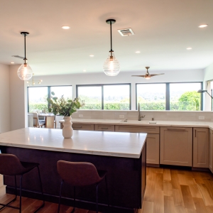 Large kitchen island with pendant lighting and wide window views