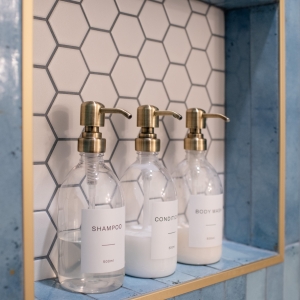 Hall bathroom shower niche with white hex tile