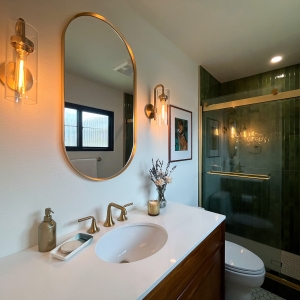 Primary bathroom vanity beside the green tiled shower